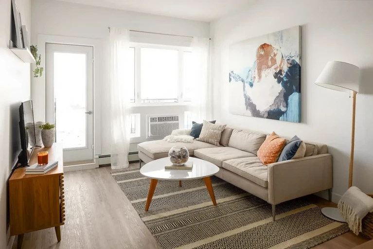Bright living room with large windows at The Parkway in Saskatoon.