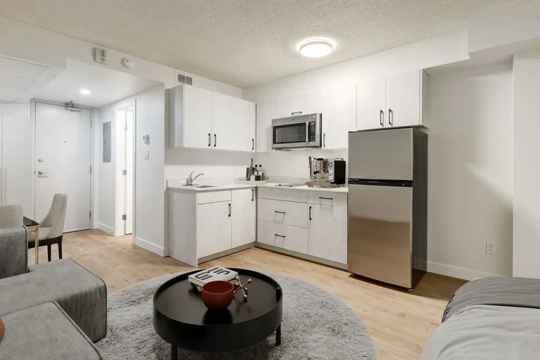 Bright modern kitchen with stainless steel appliances at The SunRise in Edmonton.