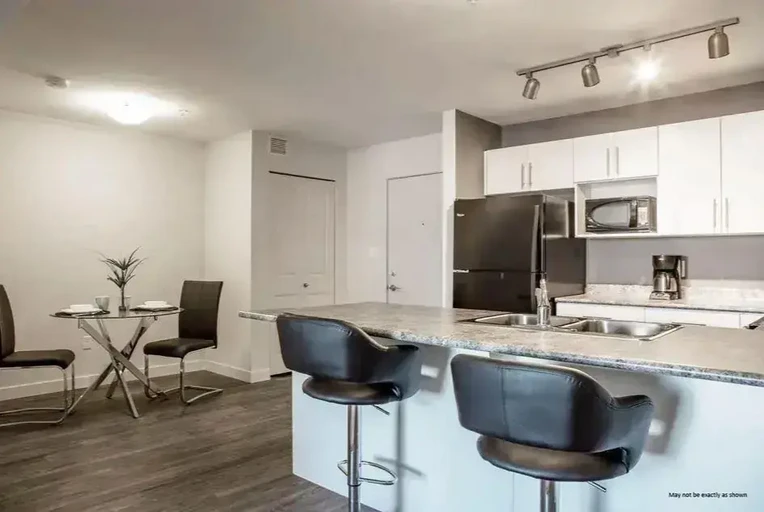 Updated kitchen featuring  fridge and stove at King's Heights in Airdrie.