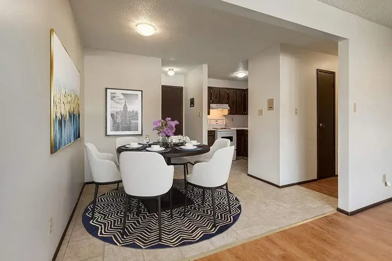 Dining area with access to living room and kitchen at Central Apartments in Brooks.