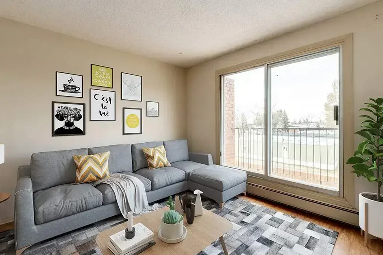 Bright living room with large windows at Greenbrook Apartments in Brooks.