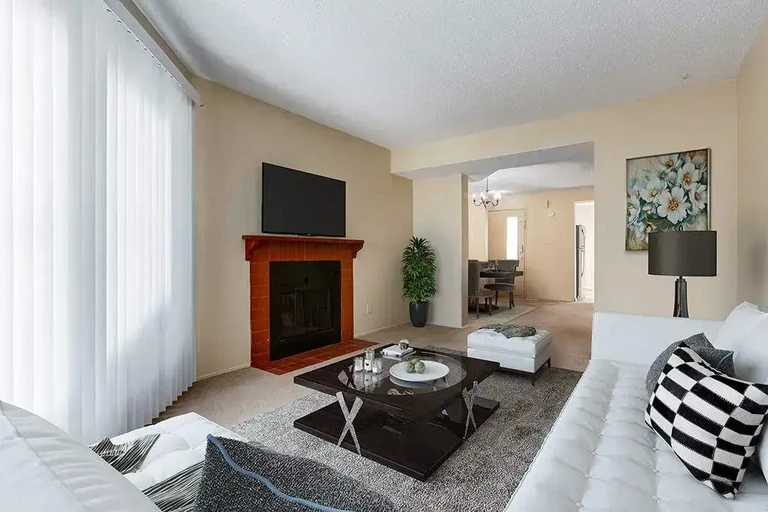 Bright living room with natural light at Sunridge Village in Calgary.