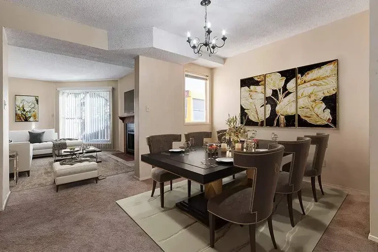 Airy living room with bright windows at Sunridge Village in Calgary.