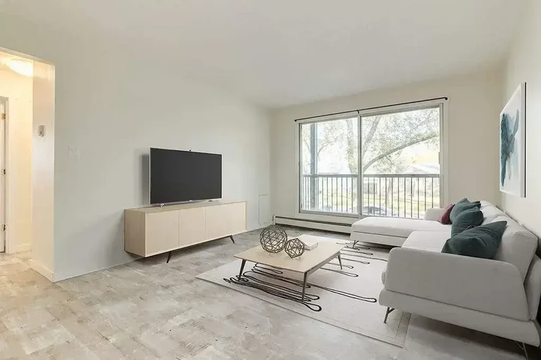 Living room filled with natural light at  at Evergreen Apartments in Camrose.