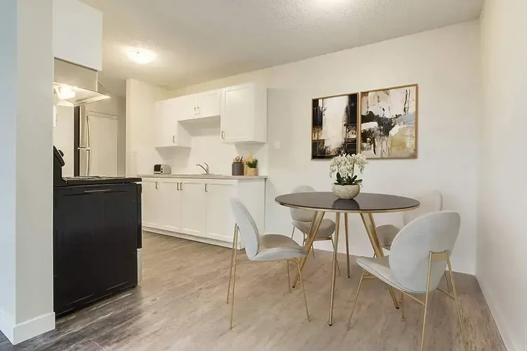 Galley style kitchen with dining corner at North Star Apartments in Camrose.