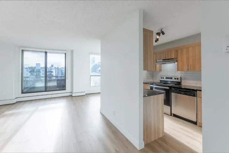 Kitchen and living room with large windows at Belmont House in Calgary.