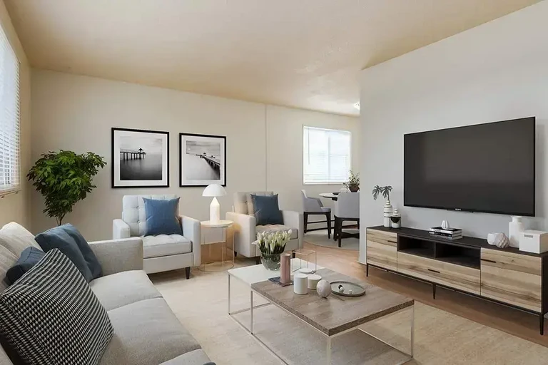 Bright living room with large windows at Allen Manor.