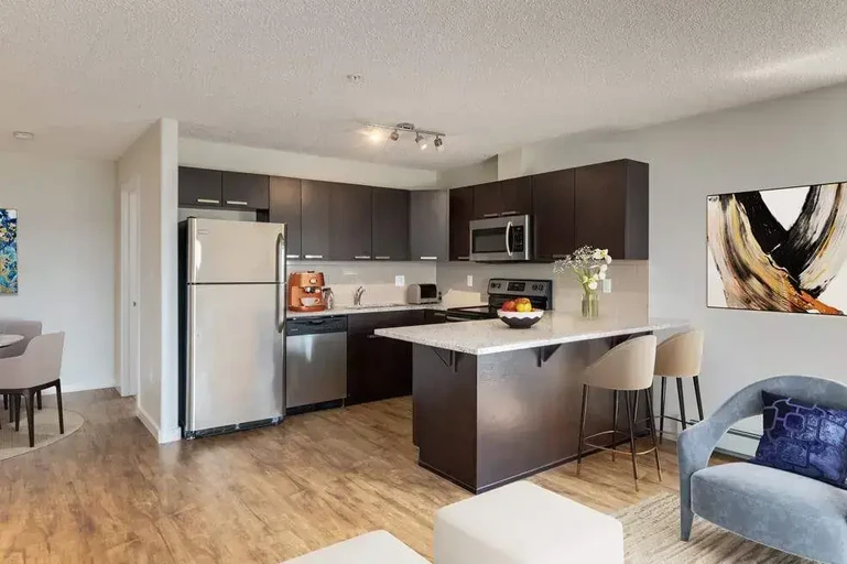 Modern kitchen with stainless steel appliances at Avalon Court in Edmonton.