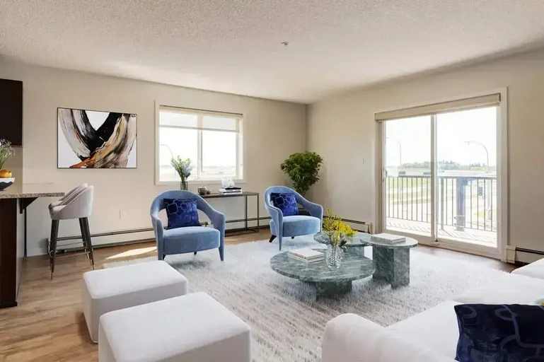 Bright living room with large windows at Avalon Court in Edmonton.