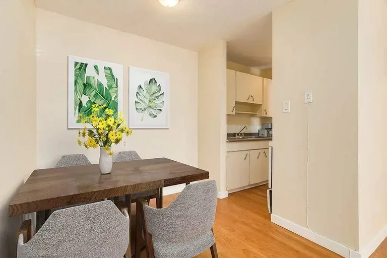 Dining area and access to the galley kitchen at Canada West Courts in Edmonton.