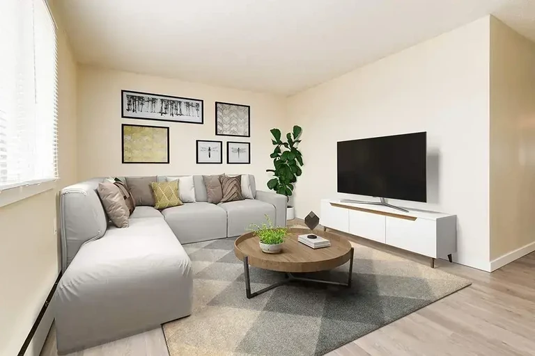 Bright living room with large windows at Cloverdale Apartments in Edmonton.