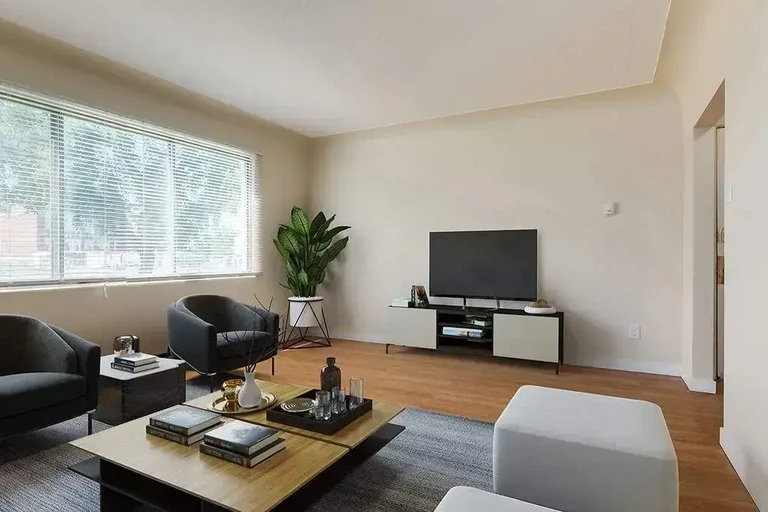 Airy living room with bright windows at Eastwood Apartments in Edmonton.