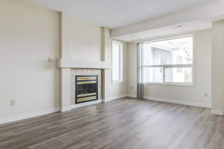 Living room with large windows and natural light at Huntington Court Coach Homes in Edmonton.