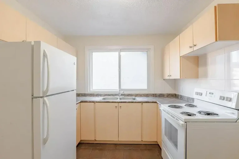 Bright open-concept kitchen area at Steven Manor in Edmonton.