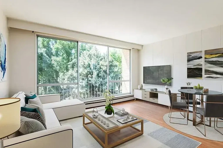 Bright living room with large windows at Applewood in Lethbridge.