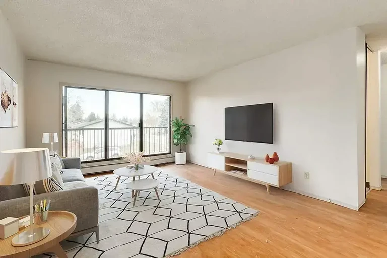 Airy living room with bright windows at Ruby Court in Lethbridge.