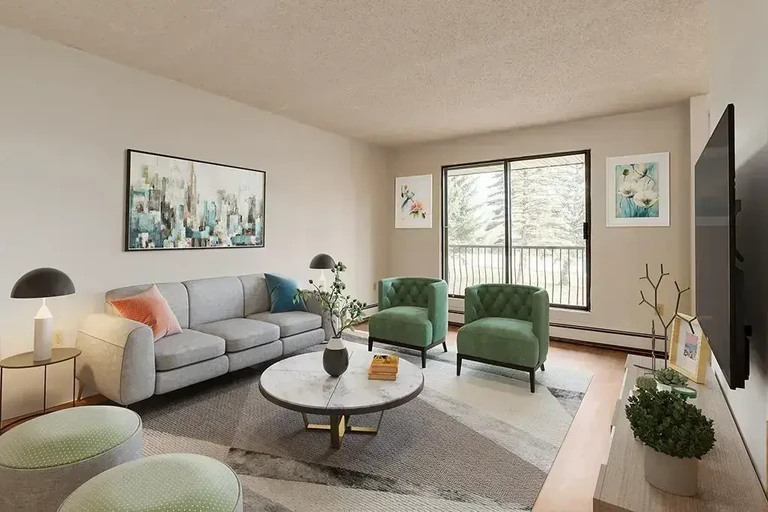 Bright living room with large windows at Westwood Apartments in Lethbridge.