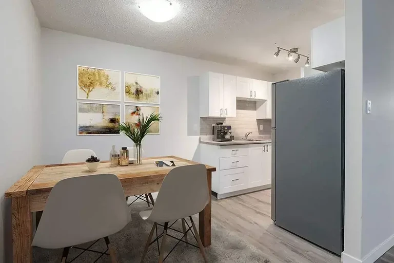 Dining area and kitchen at Camden Villa in Medicine Hat.