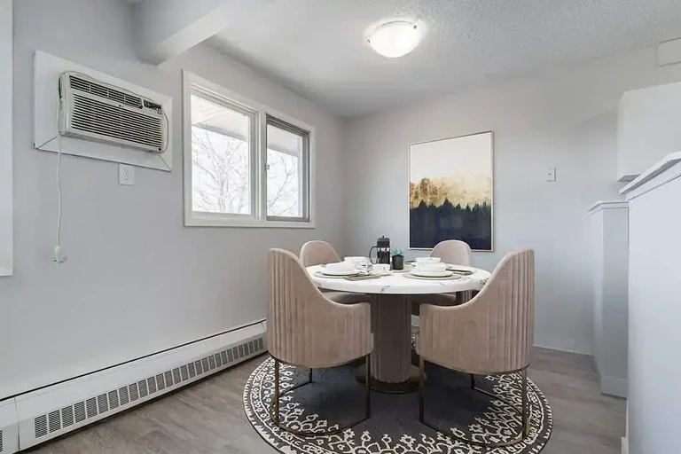 Dining area with natural light at MacKenzie Manor in Regina.