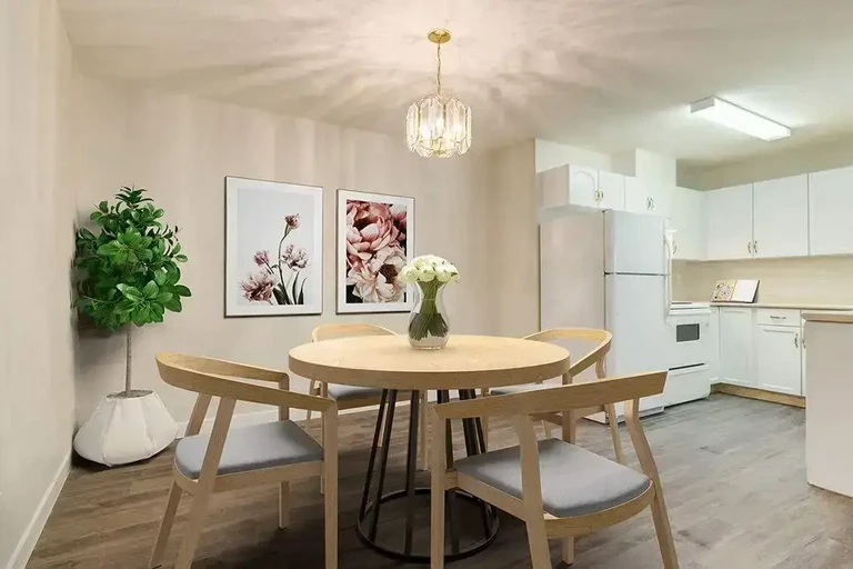 Dining area and open concept kitchen at Crowchild Court in Wetaskiwin.