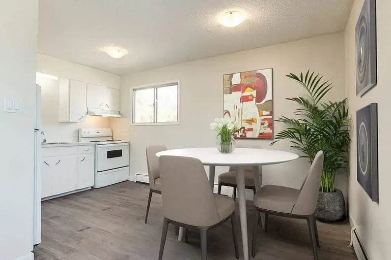 Open-layout kitchen with dining area at Dickson Apartments in Wetaskiwin.