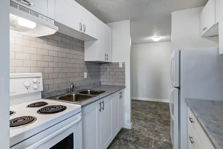 Galley style kitchen with appliances at Parkview Place in Yorkton.