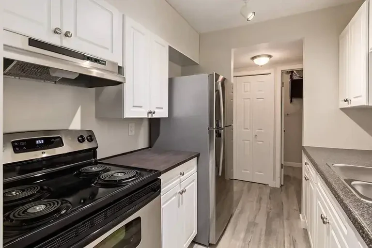 Contemporary kitchen with stainless steel appliances at Fairway Plaza in Medicine Hat.