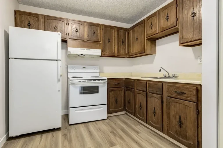 Functional kitchen with appliances at Grand Park Village in Camrose.