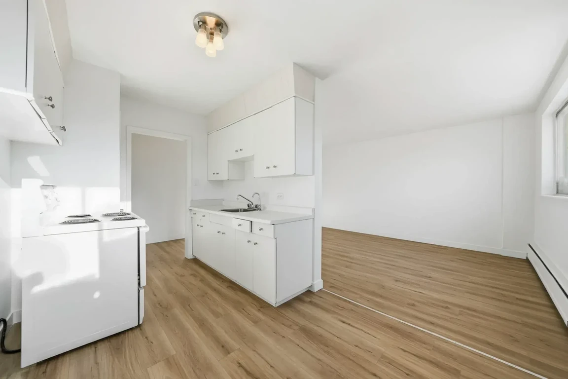 Open kitchen design connected to living space at Lord Robinson Apartments in Regina.