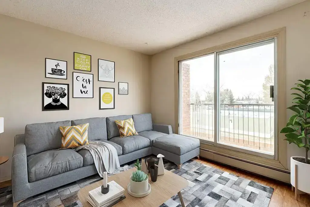 Bright living room with large windows at Greenbrook Apartments in Brooks.