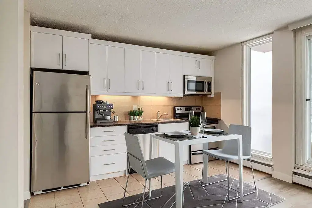 •	Open-concept kitchen layout at Alumni Apartments in Calgary.