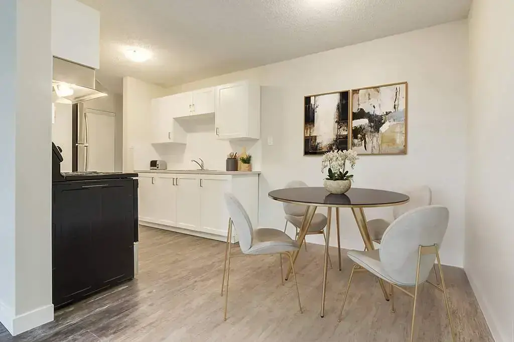 Galley style kitchen with dining corner at North Star Apartments in Camrose.