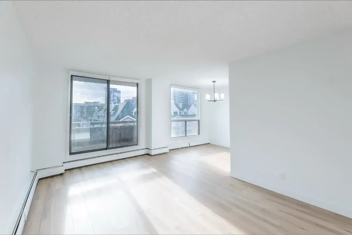 Bright living room with large windows at Belmont House in Calgary.