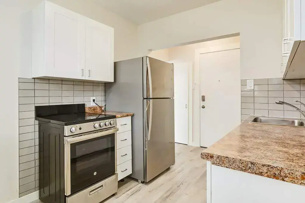 Modern Kitchen with stainless steel fridge and stove at Albert Manor.