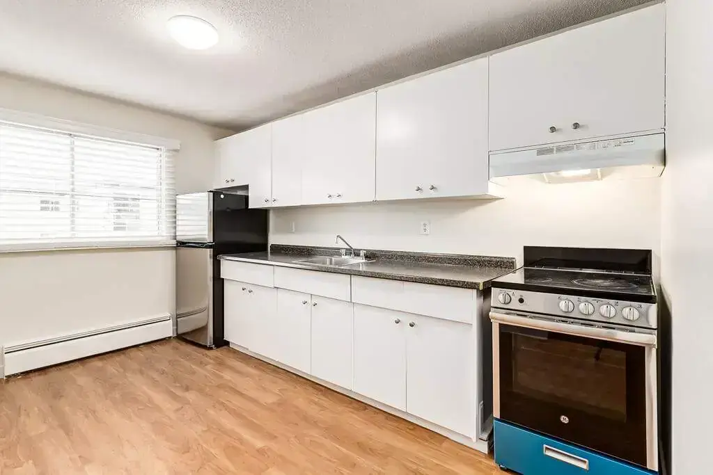 Stylish kitchen with stainless steel fridge and stove at Emerald Vista in Edmonton.