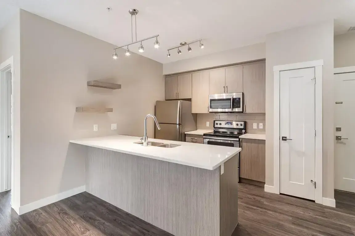Modern kitchen with stainless steel appliances at The Level in Edmonton.