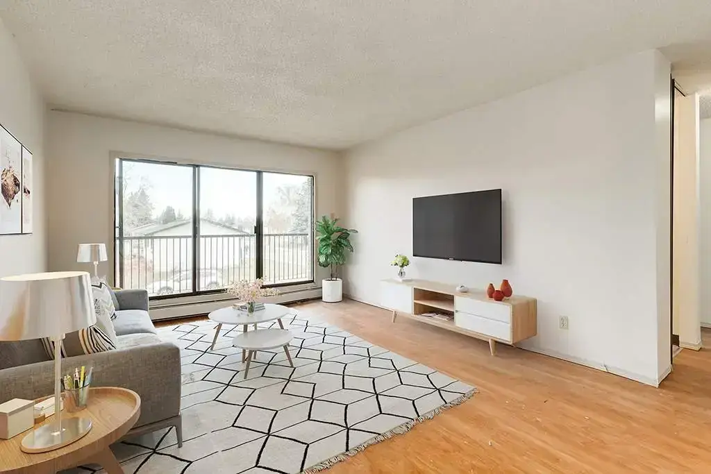 Airy living room with bright windows at Ruby Court in Lethbridge.