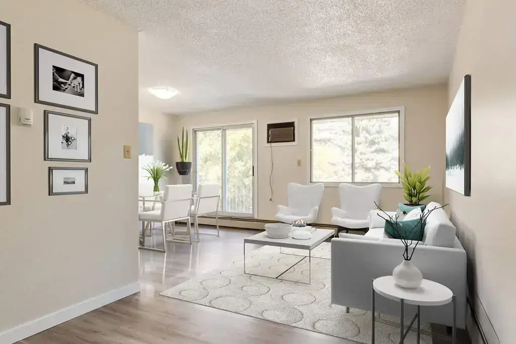 Bright living room with large windows at Casa Linda in Medicine Hat.
