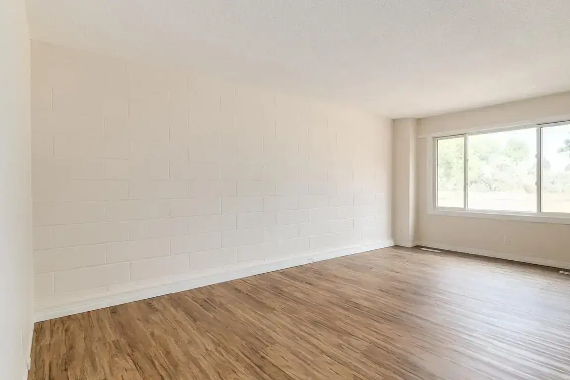 Bright living room with large windows at Parkland Townhomes in Medicine Hat.