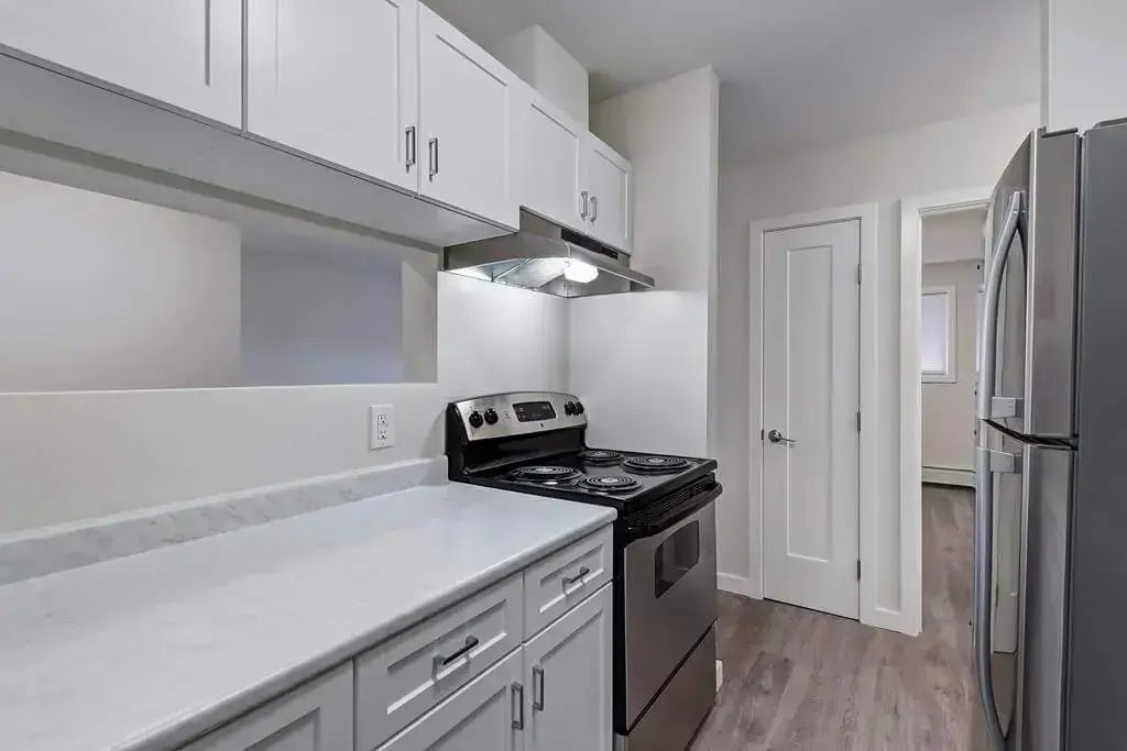 Modern kitchen with stainless steel appliances at Heritage Place Apartments in Prince Albert.