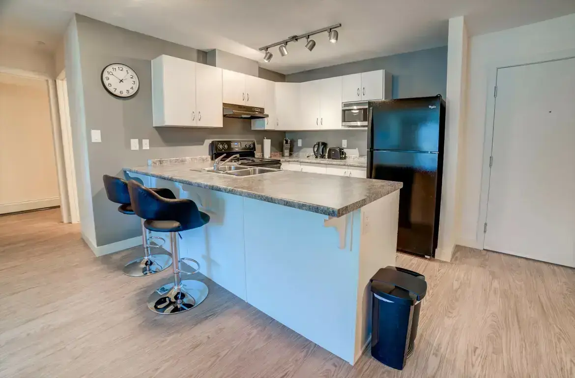 Stylish kitchen with large breakfast bar at Vanier Woods in Red Deer.