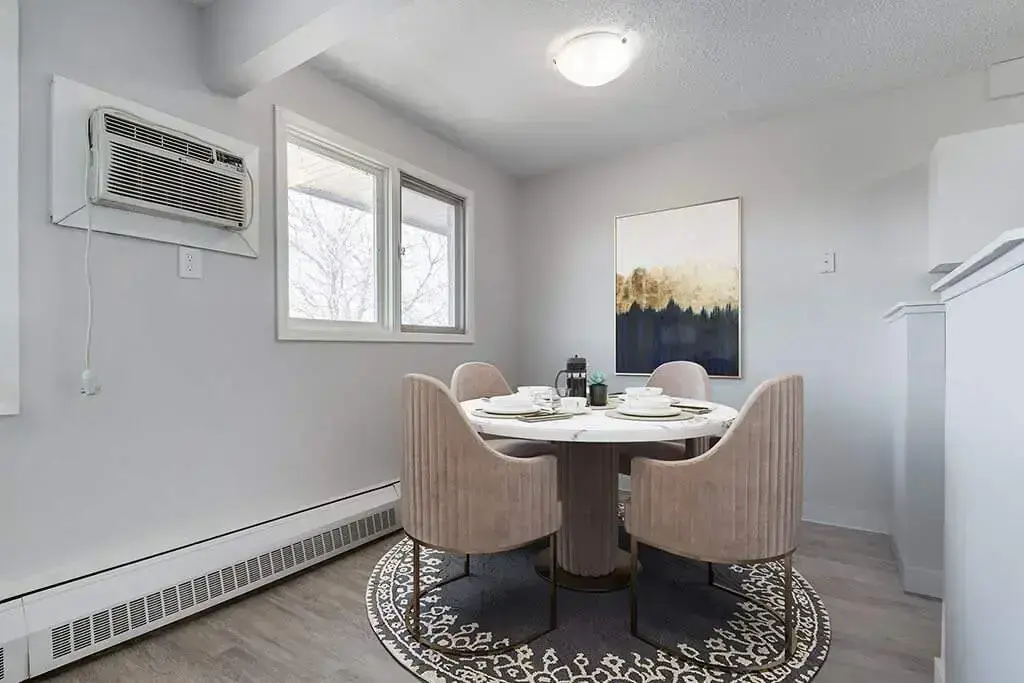 Dining area with natural light at MacKenzie Manor in Regina.