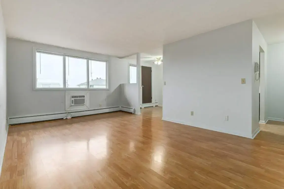 Airy living room with bright windows at Reed Manor in Regina.