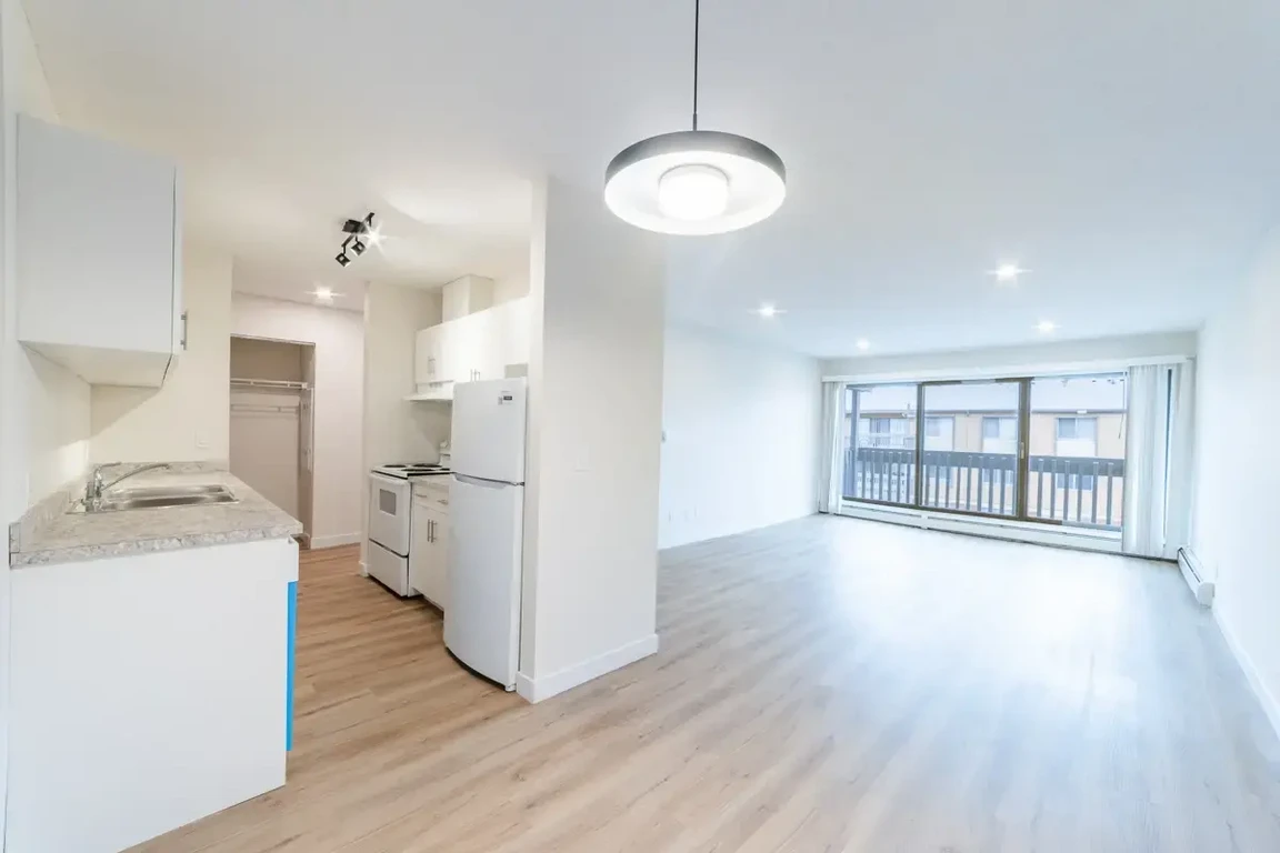 Open kitchen design connected to living space at Applewood Village in Calgary.