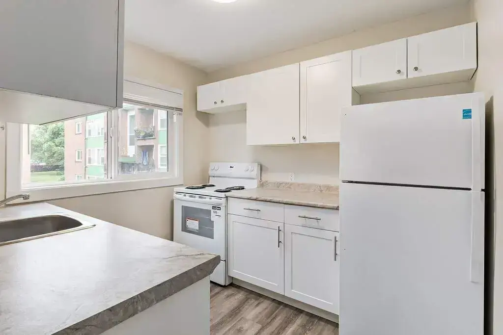 Galley style kitchen with appliances at Main Street Villa in Saskatoon.