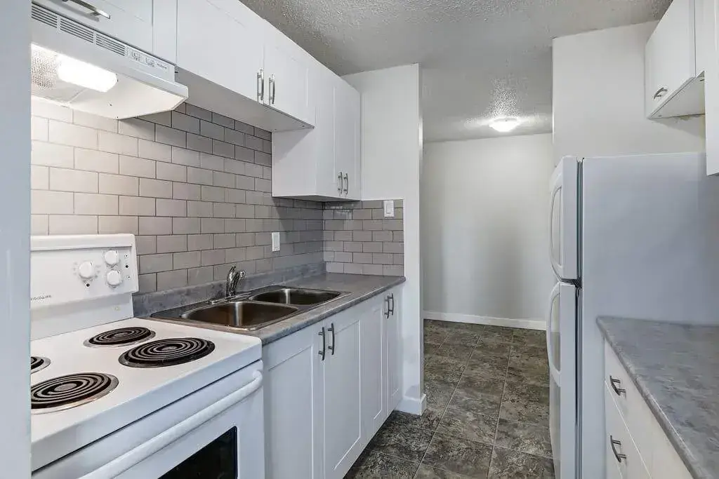 Galley style kitchen with appliances at Parkview Place in Yorkton.