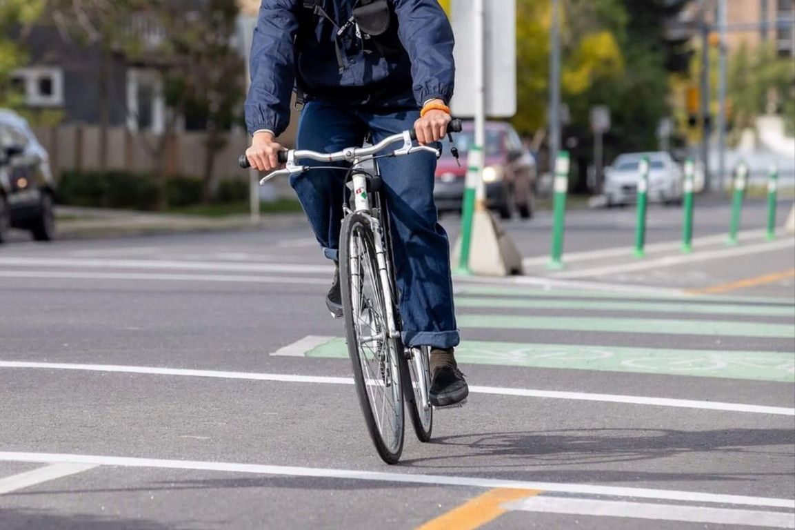 Person riding a bicycle through the street.