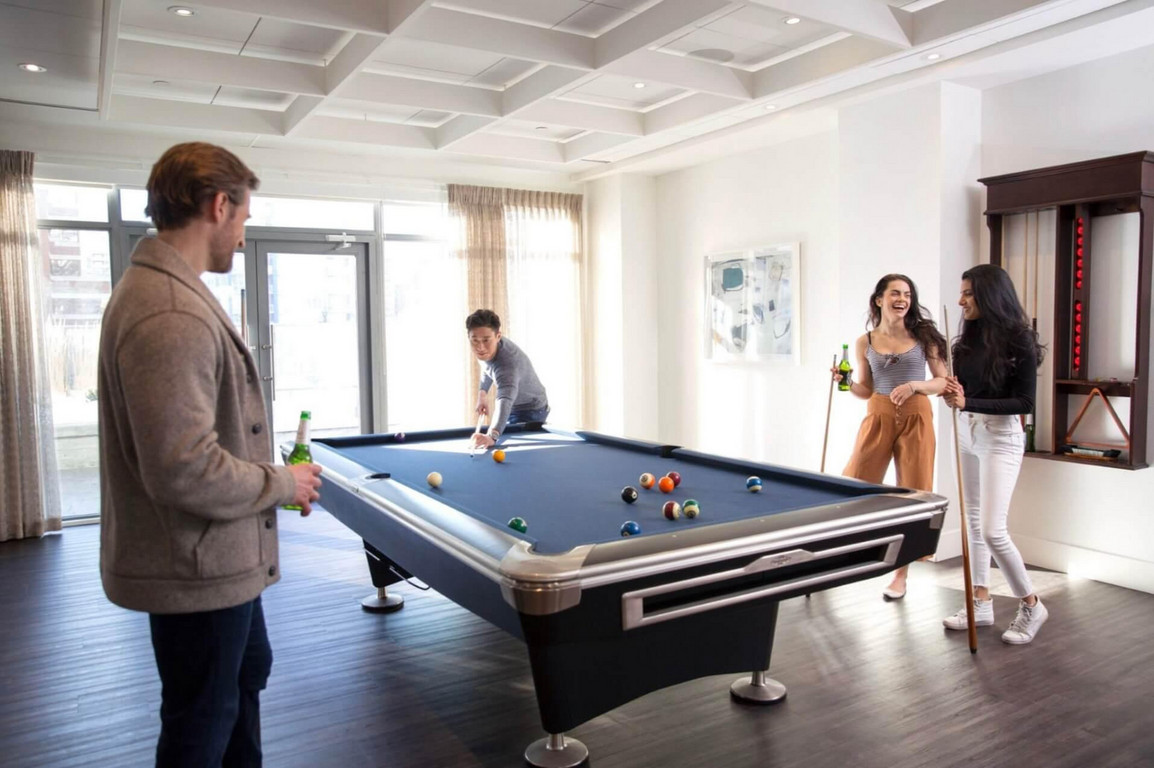 Group of people playing billiards.