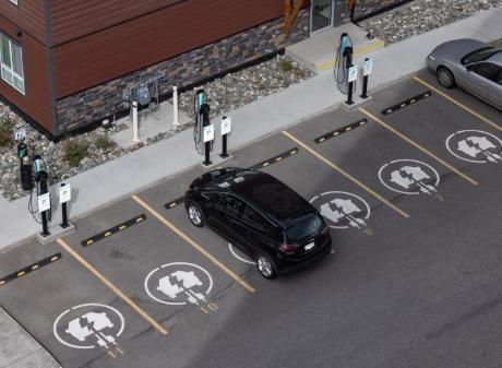 Parked car charging in parking lot