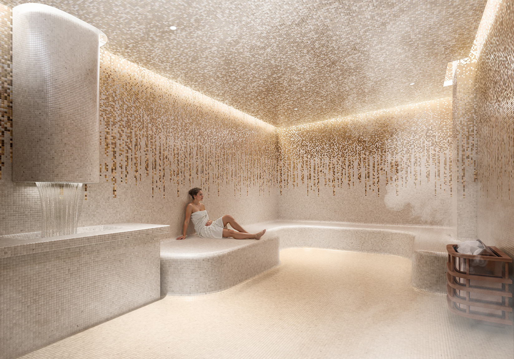 Wet hammam spa with heated stone seating and ambient mosaic tile design